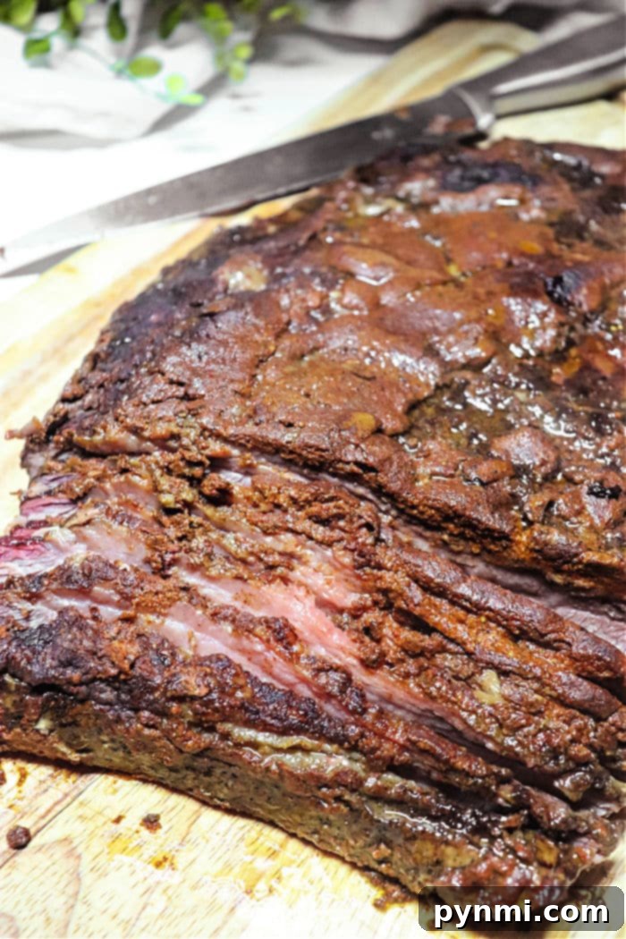 Never Overcook Your Roast Again 7 A perfectly smoked brisket flat, showcasing a beautiful caramelized bark and juicy interior, ready for precise carving.