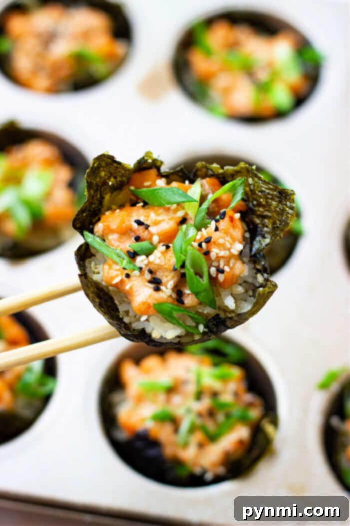 Salmon Sushi Bites 2 Salmon Sushi Cups arranged neatly in a muffin tin, ready to be enjoyed.