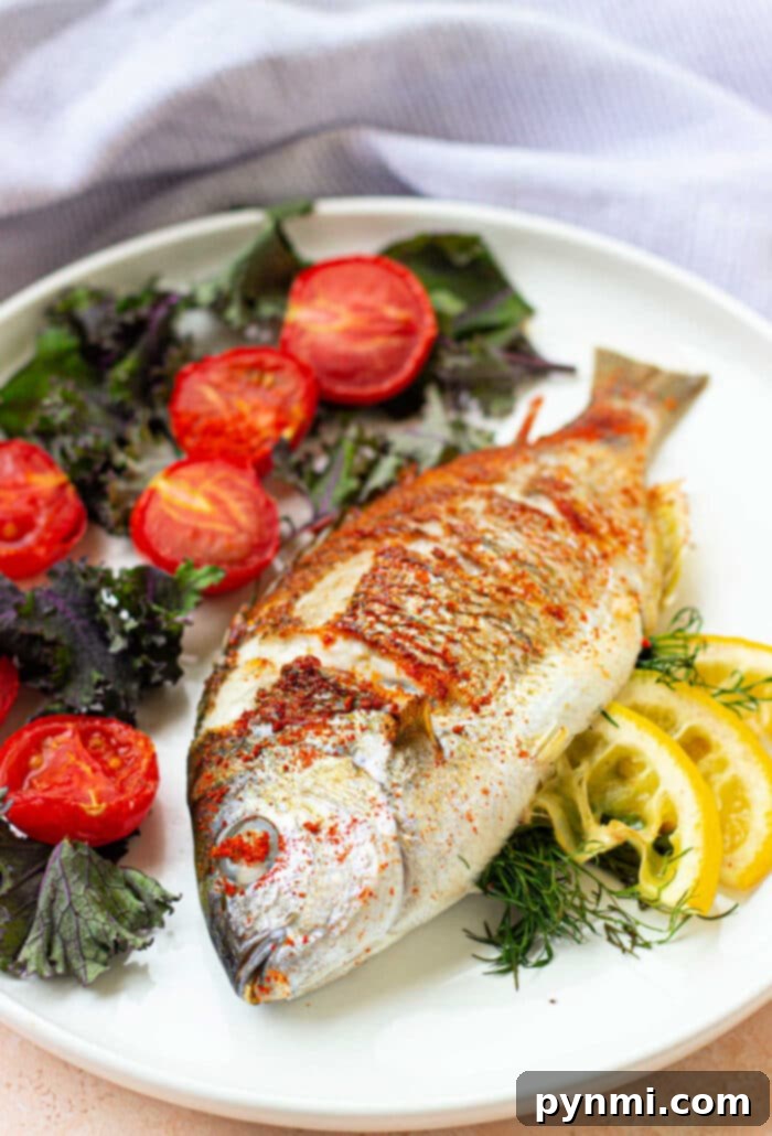How to Cook Fish in Air Fryer - a close-up of the cooked fish being served with fresh lemon