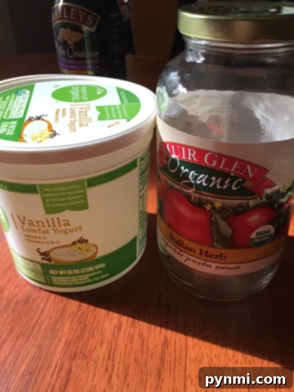 Utilize yogurt cups and glass jars as mini greenhouses for seed starting Repurposed plastic containers and a spaghetti jar used for starting plant seedlings