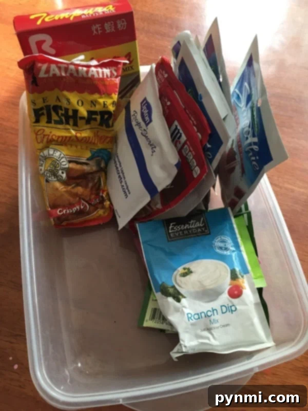 Organize kitchen packets and small items efficiently with repurposed shallow containers Shallow plastic container used to organize various kitchen packets on a shelf