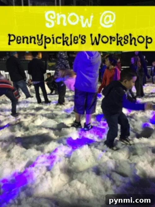 Children happily playing in real snow at Pennypickle's Workshop Temecula during a festive winter event