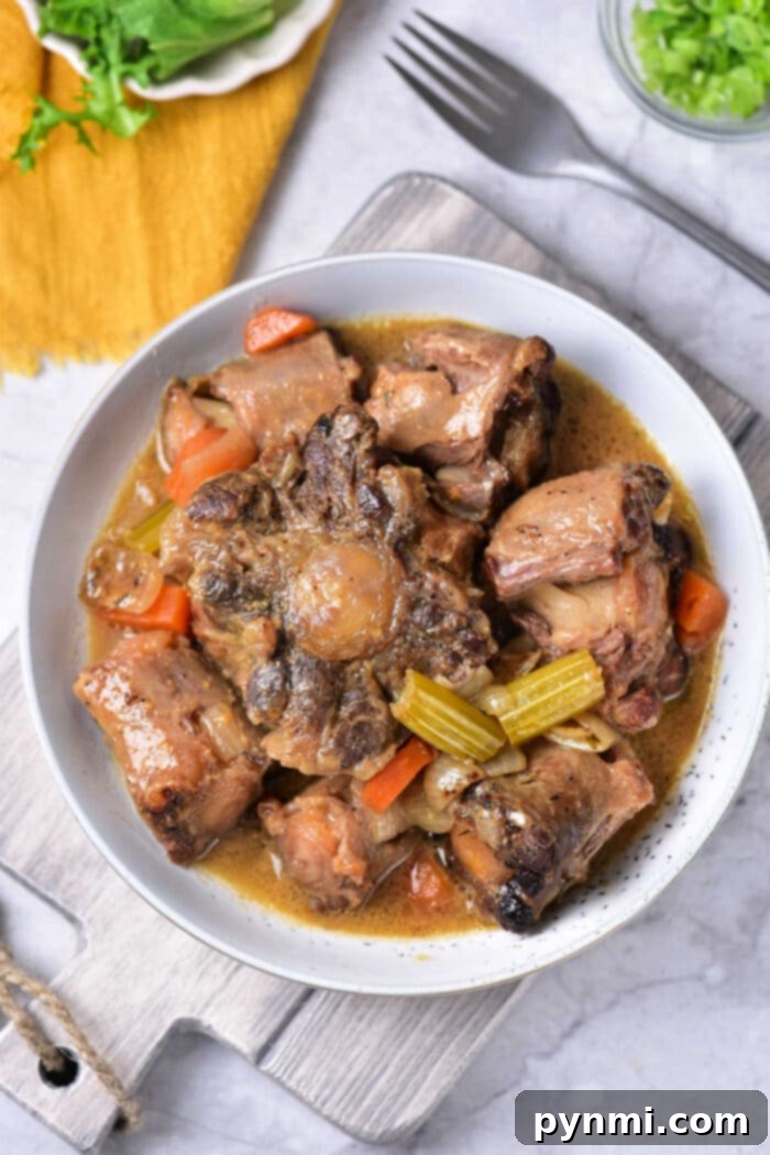 Plated Braised Oxtail with vegetables and gravy
