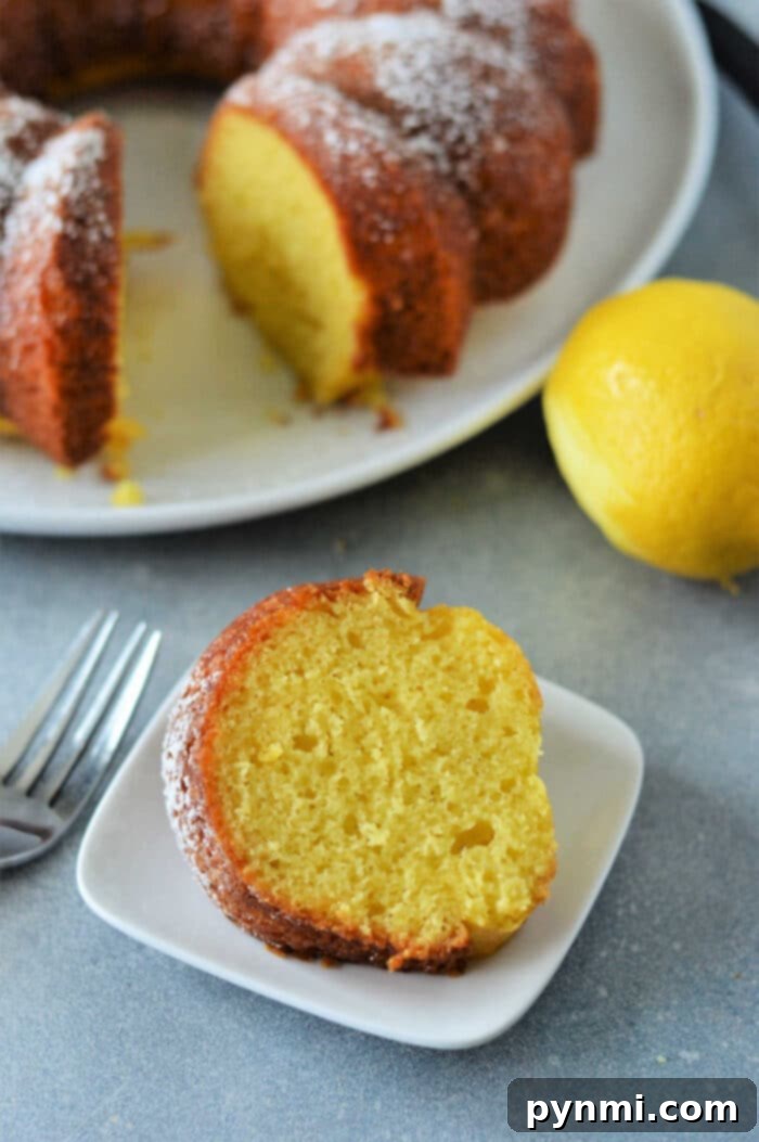 A freshly baked lemon cake cooling in a bundt pan, ready to be inverted.