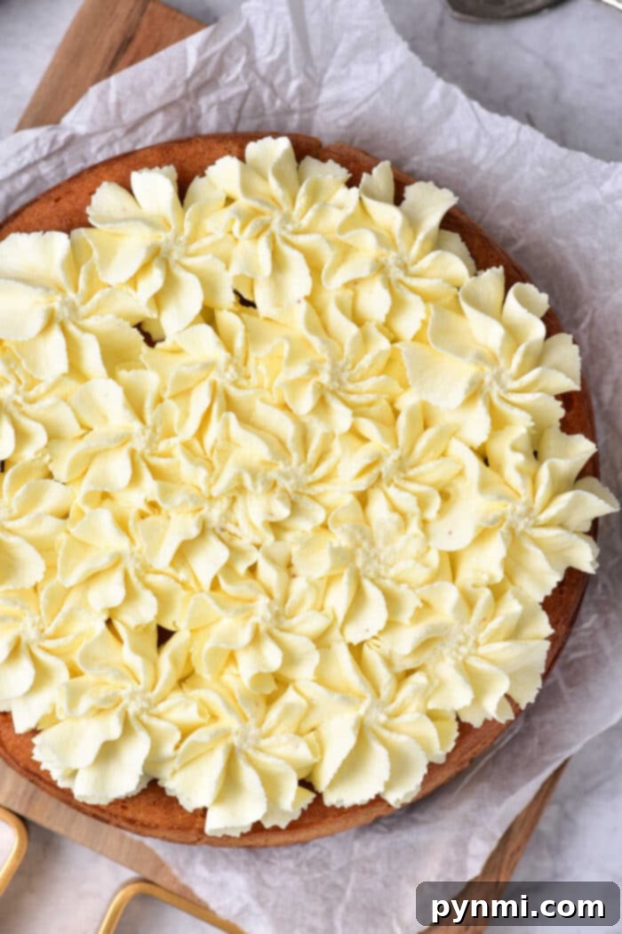 A beautifully frosted lemon curd cake, ready for serving.