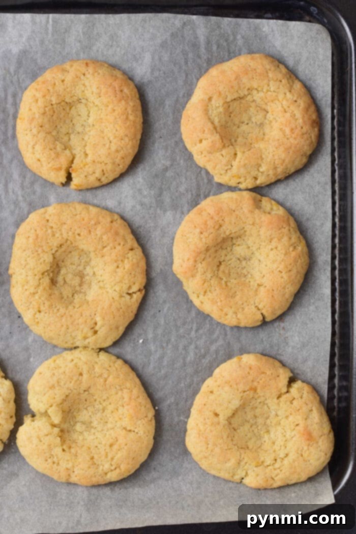 A close-up of a single perfect Lemon Curd Cookie, highlighting its texture and glossy filling.