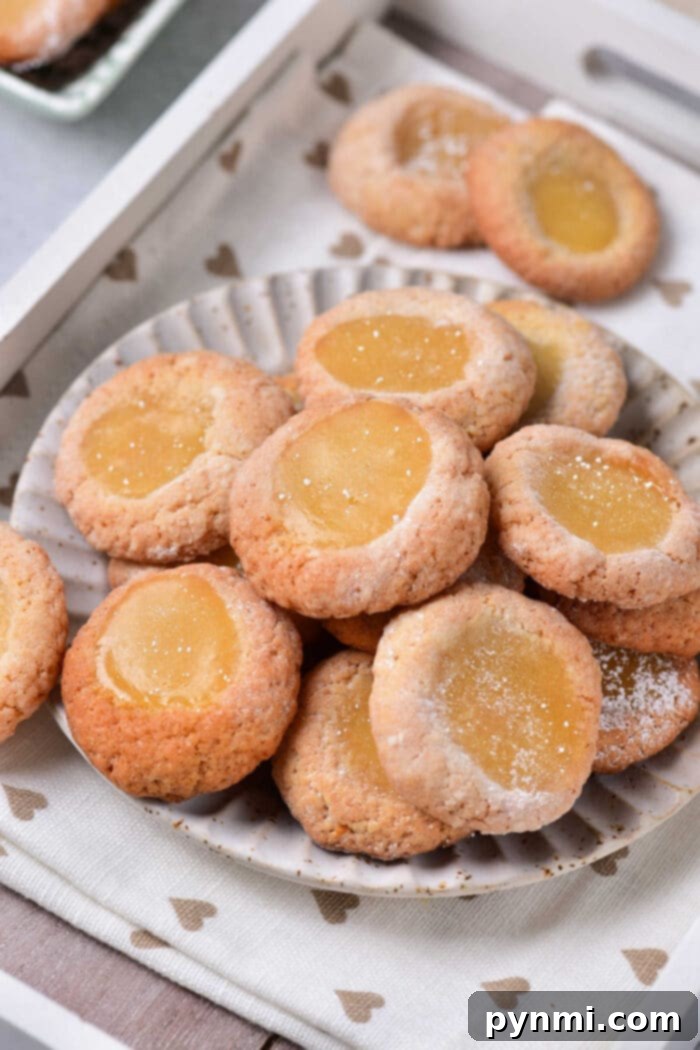A generous platter filled with freshly baked and filled Lemon Curd Cookies, ready for serving.