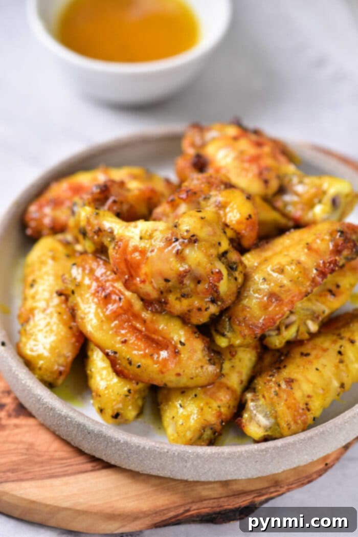 Honey Lemon Pepper Wings served on a platter, showcasing their golden-brown crispiness and delicious glaze.