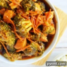 A bowl of Instant Pot Chicken and Broccoli stir-fry is perfectly complemented by carrots in a savory sauce, served with a side of rice.