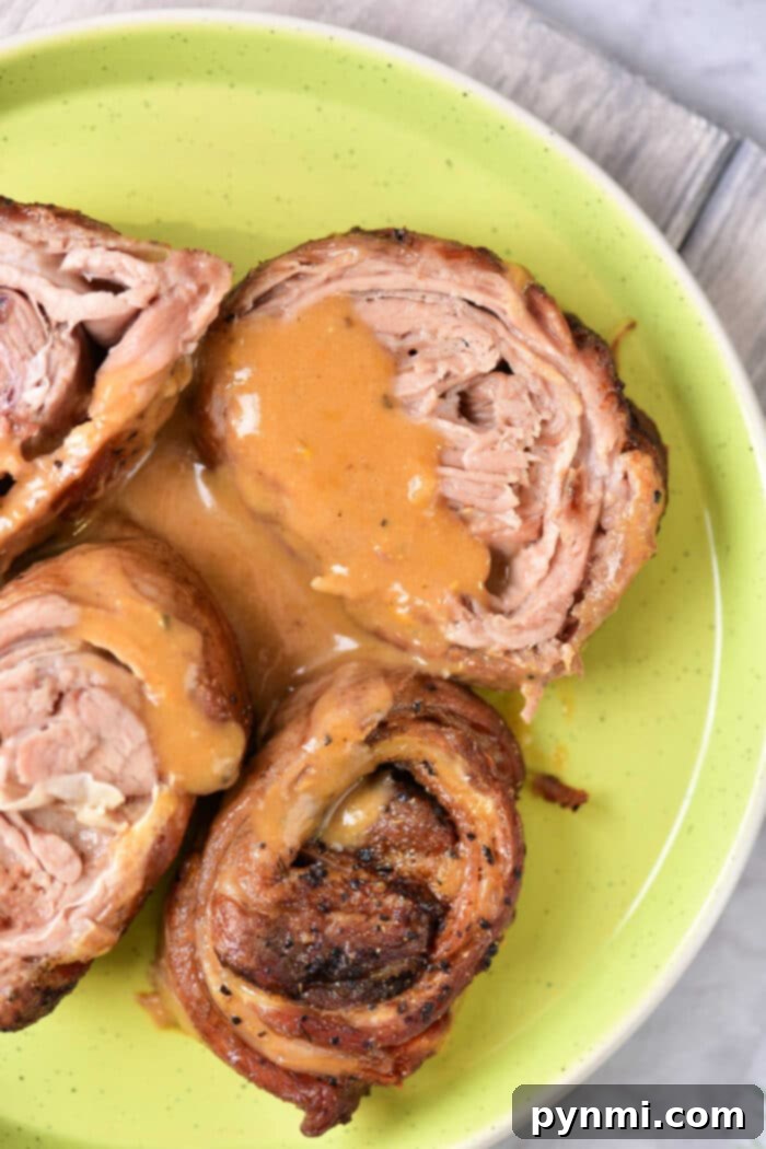 Succulent Lamb Breast Secrets 2 Savor the taste of rolled lamb breast with sauce, artfully presented on a green plate. For those intrigued by variety, this dish pairs beautifully with our Lamb Breast Recipe, offering a delightful blend of flavors that's sure to please your palate.