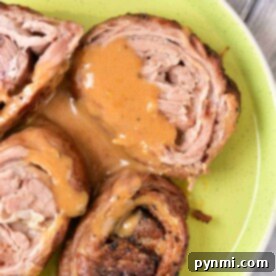 Savor the taste of rolled lamb breast with sauce, artfully presented on a green plate. For those intrigued by variety, this dish pairs beautifully with our Lamb Breast Recipe, offering a delightful blend of flavors that's sure to please your palate.