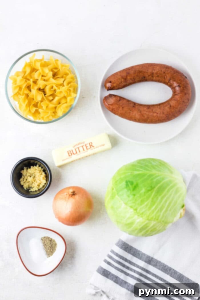 Effortless Slow Cooker Haluski 3 Golden brown kielbasa slices mixed with wilted cabbage and tender egg noodles, cooked to perfection in a large skillet on the stove.
