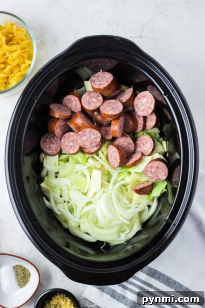 Effortless Slow Cooker Haluski 4 Hearty slow-cooked kielbasa and tender cabbage, a perfect pairing for a delicious Haluski meal.