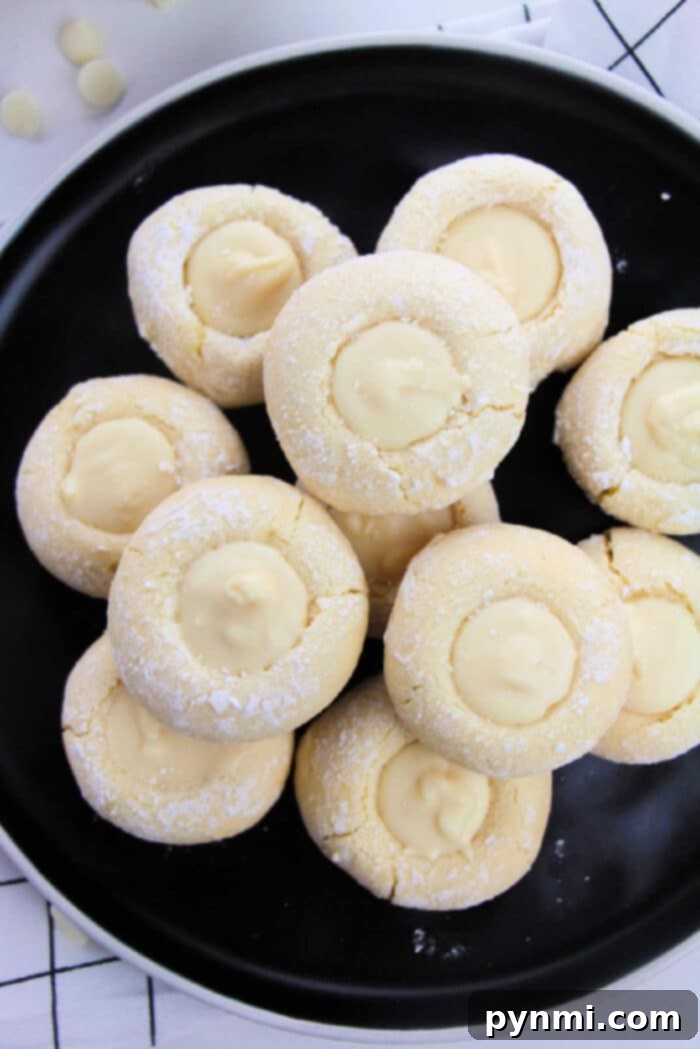 Sunshine Lemon Cake Mix Cookies 2 Delicious Lemon Cake Mix Thumbprint Cookies arranged on a cooling rack, showcasing their golden edges and potential for various fillings.