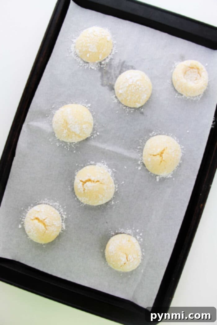 Sunshine Lemon Cake Mix Cookies 3 Close-up of golden-brown Thumbprint Cookies made with cake mix, before filling, showing their signature indentation.
