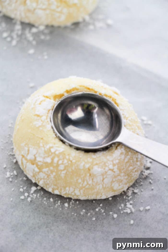 Sunshine Lemon Cake Mix Cookies 4 Freshly baked Lemon Cake Mix Thumbprint Cookies cooling on a wire rack, ready for their delicious filling.