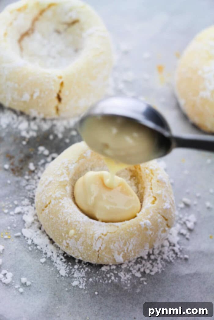 Sunshine Lemon Cake Mix Cookies 6 A tray of beautifully baked Lemon Cake Mix Cookies, some with a dusting of powdered sugar, waiting to be filled.