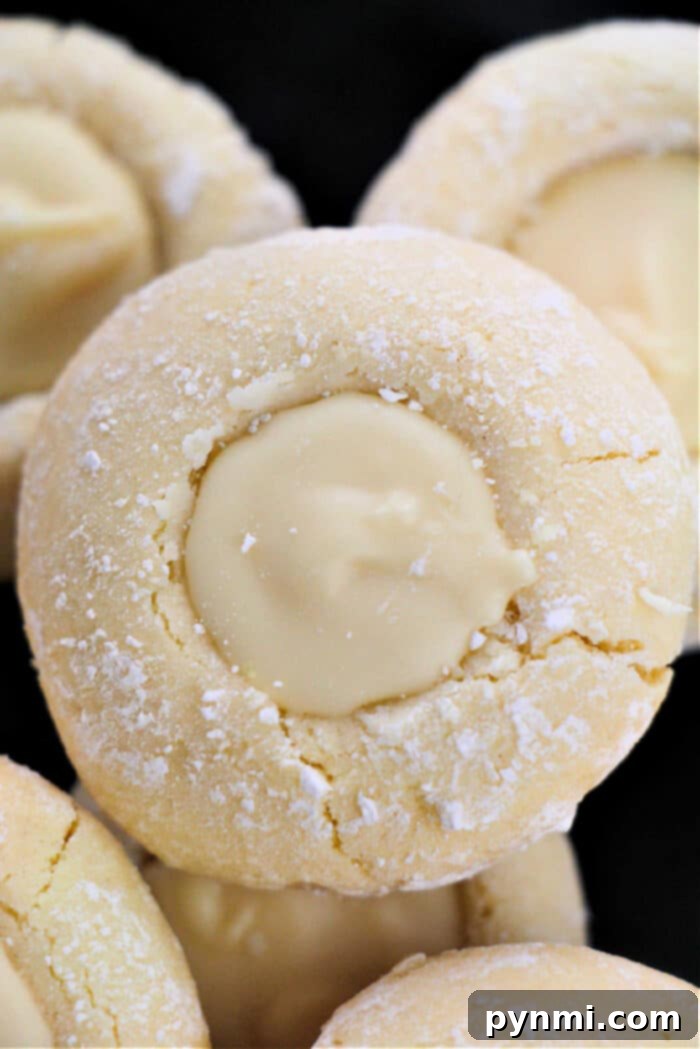 Sunshine Lemon Cake Mix Cookies 7 A close-up shot of Lemon Cookies From Cake Mix, beautifully filled with a yellow curd, showcasing their inviting texture.