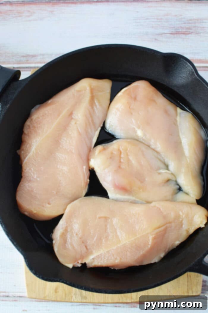 Cast Iron Chicken Breast - chicken sizzling in garlic butter sauce