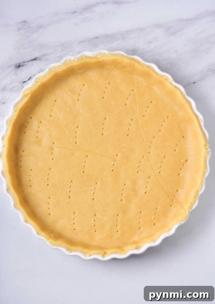 Flaky Quiche Foundation 2 Perfectly blind-baked quiche crust in a pie dish, ready for filling