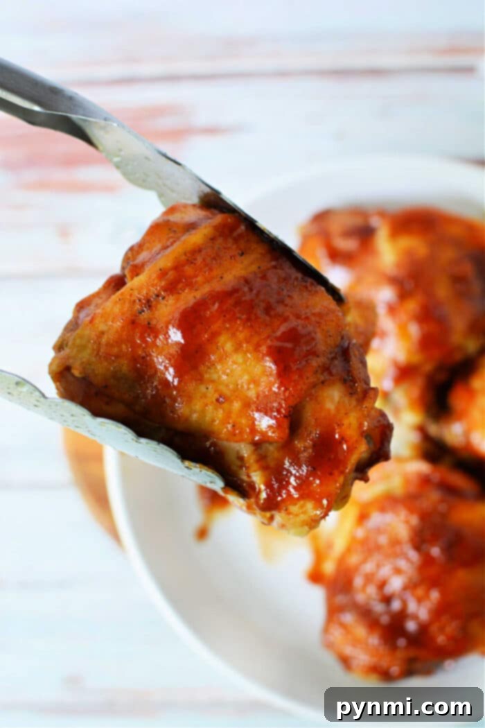 Juicy Instant Pot BBQ Chicken Thighs 2 Instant Pot BBQ Chicken Thighs served on a plate, garnished with fresh herbs