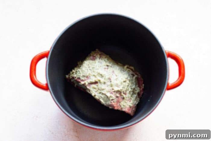 A delicious Cross Rib Roast Recipe, served with gravy and herbs.