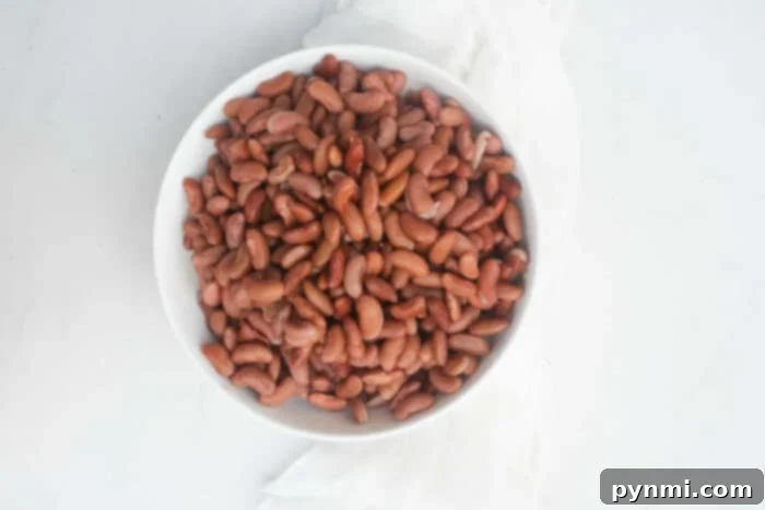 From Dry to Delicious: Cooking Kidney Beans 3 Close-up of dried kidney beans soaking in water, illustrating the preparation step before cooking.