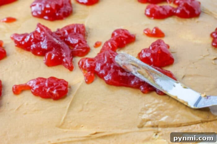 Delicious Peanut Butter and Jelly Cinnamon Rolls with icing