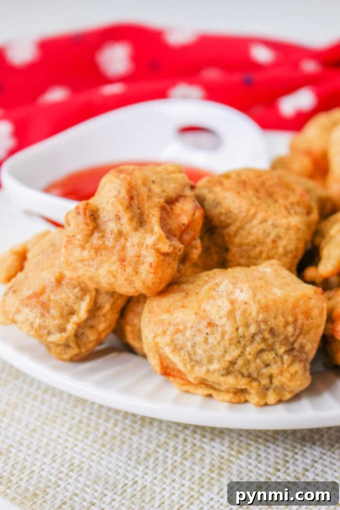 Crispy Tempura Chicken Nuggets served with a variety of colorful dipping sauces on a vibrant plate.