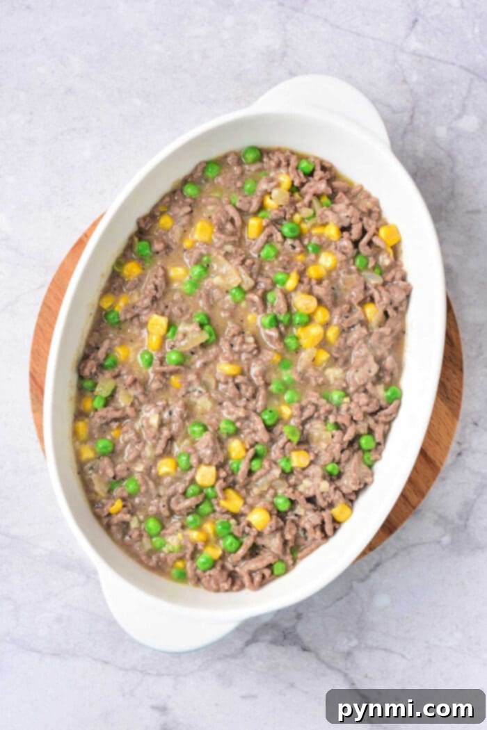 Hearty Beef and Hash Brown Bake 4 Hearty casserole with hash browns, ground beef, and a golden-brown cheese topping