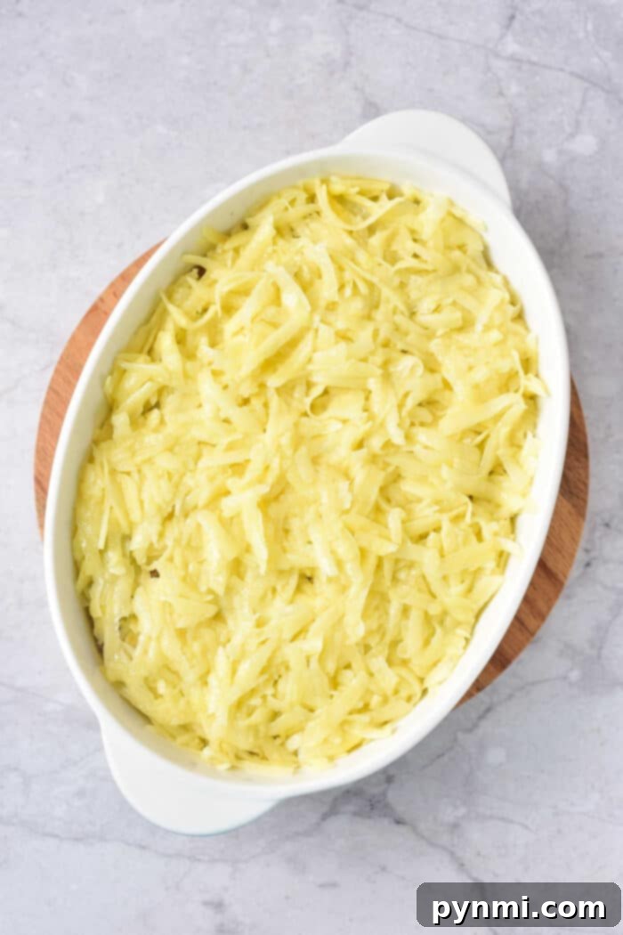 Hearty Beef and Hash Brown Bake 5 A vibrant frozen hash brown casserole baked to perfection, garnished with fresh herbs.