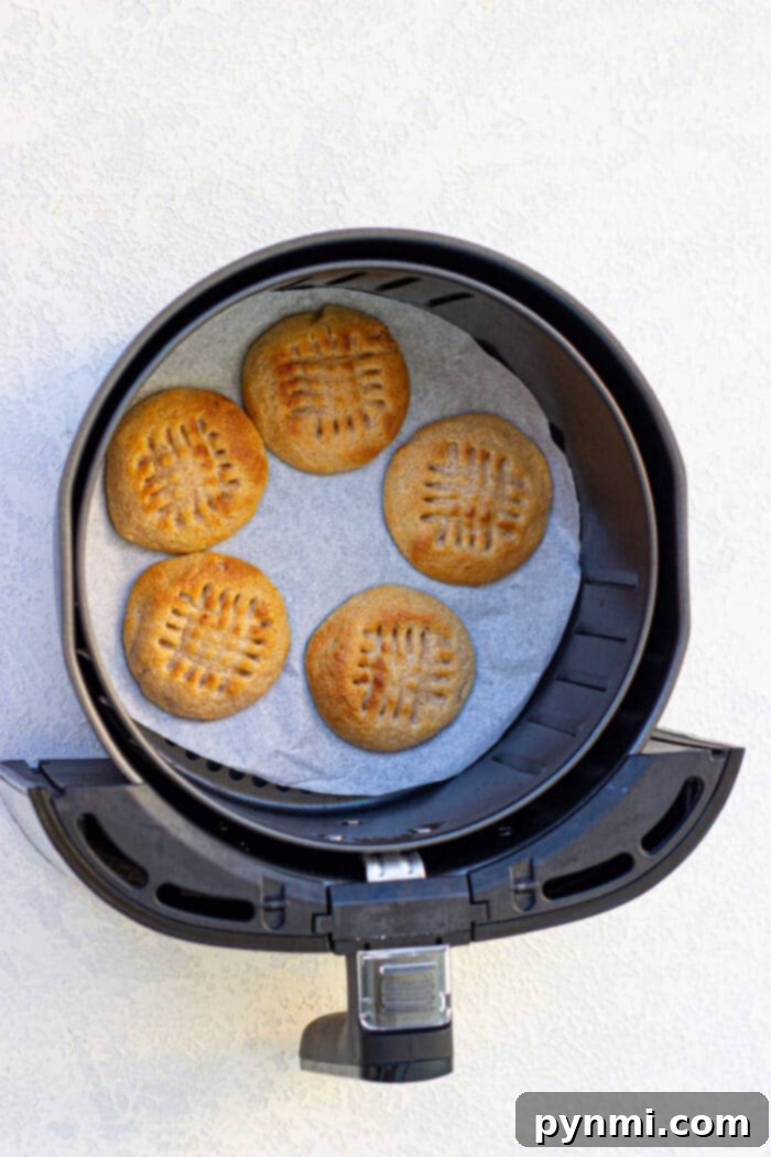 Golden Air Fryer Peanut Butter Delights 5 A close-up of a perfectly baked peanut butter cookie with a clear criss-cross pattern, made in a Ninja Foodi air fryer.