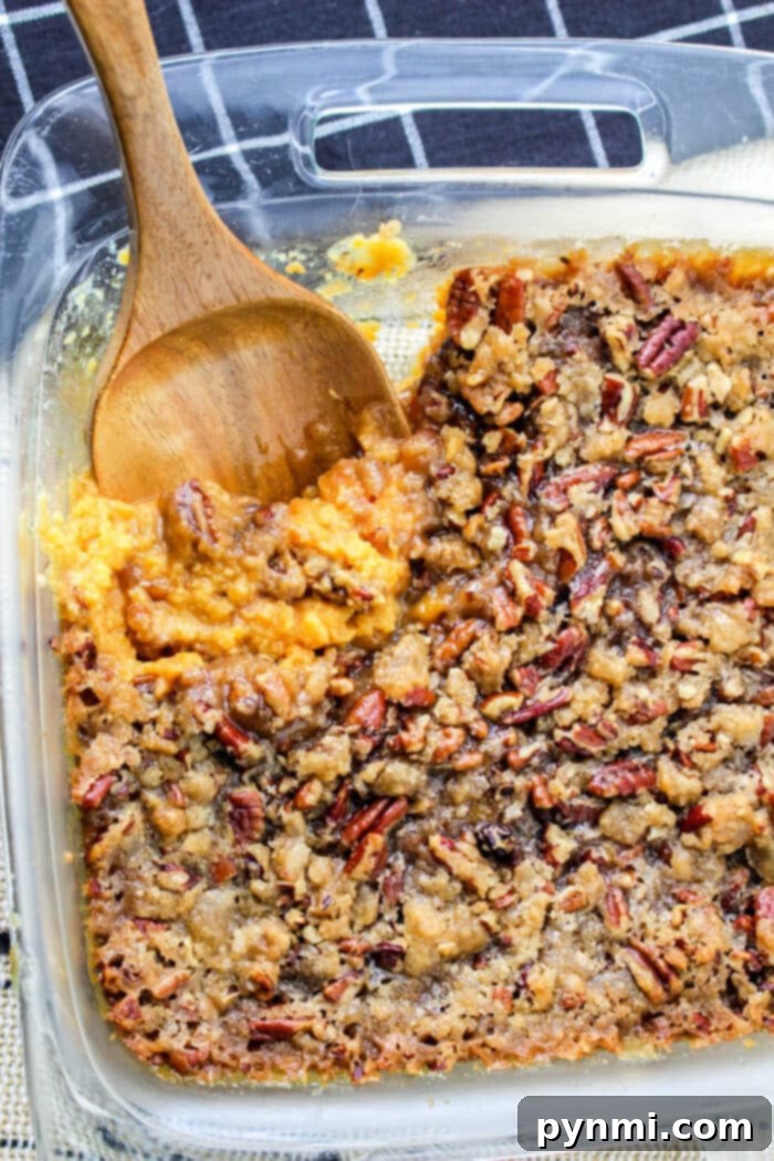Sweet Potato Casserole Recipe with Canned Yams, topped with toasted pecans and a golden-brown crust, ready to be served