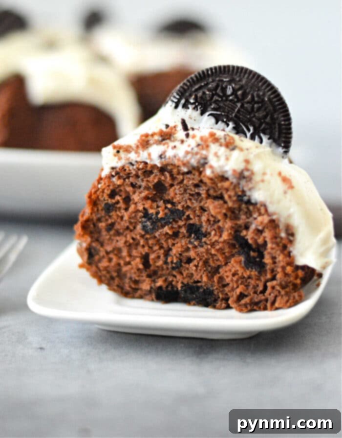 Oreo Bundt Cake: A visually appealing chocolate bundt cake topped with white frosting and crushed Oreo cookies, ready to be served.
