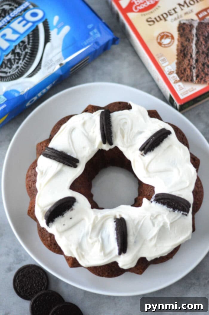 A beautifully frosted slice of Cake Mix Oreo Bundt Cake, revealing the Oreo pieces baked inside, ready to be enjoyed.