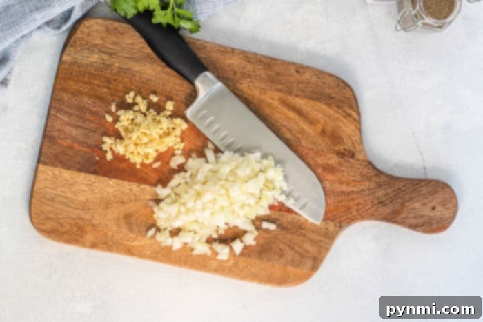 Fresh garlic cloves and sliced onions, common aromatics often paired with corned beef.