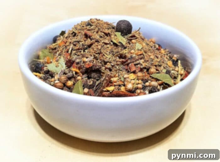 A cast iron skillet, ideal for toasting corned beef spices, with some whole spices visible.