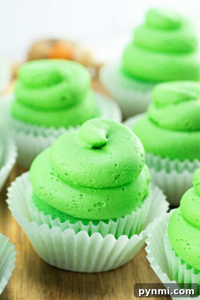Velvet Curd Cupcakes 7 A tray of beautifully decorated lime cupcakes, showcasing their vibrant green frosting and inviting texture.