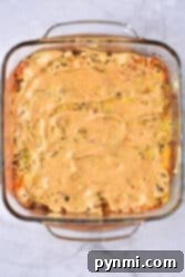 Ultimate Big Mac Bake 9 A square glass dish with a creamy Big Mac casserole sits enticingly on a marble surface.