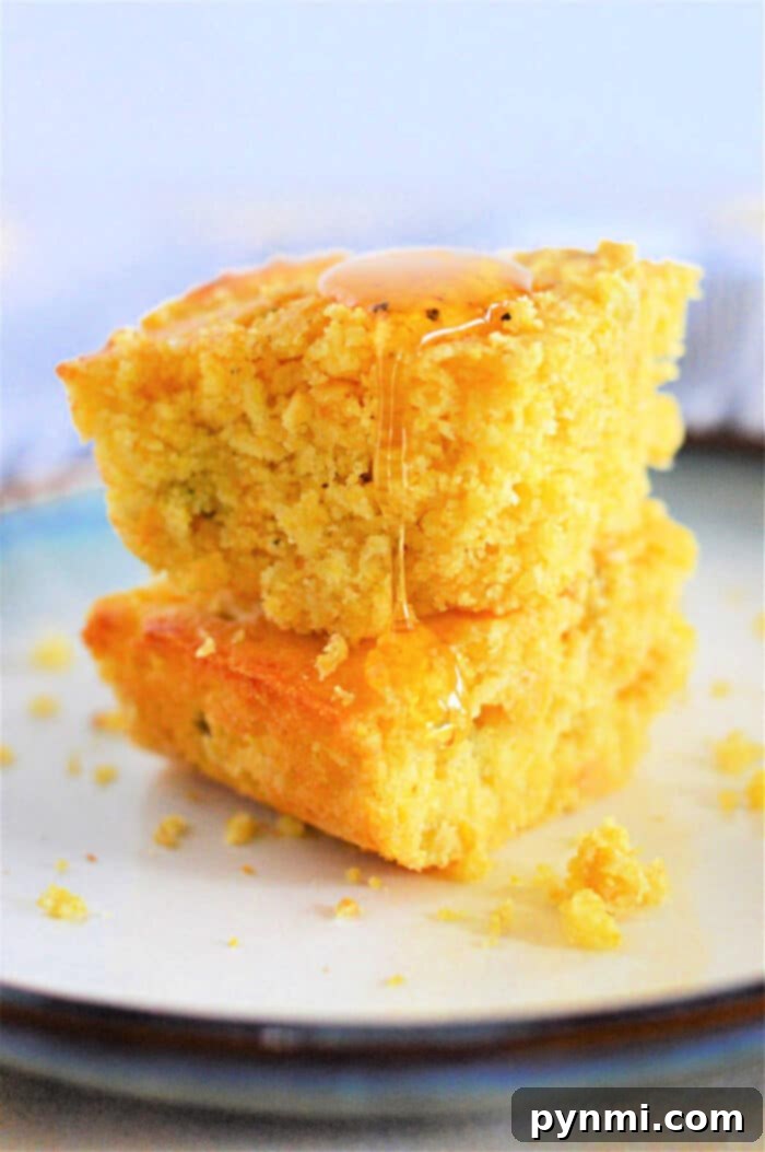 Golden Dairy-Free Cornbread 2 Deliciously golden dairy-free cornbread squares cooling on a wire rack.