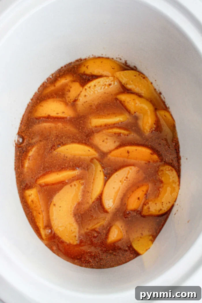 peach cobbler in a slow cooker, bubbling and ready to serve