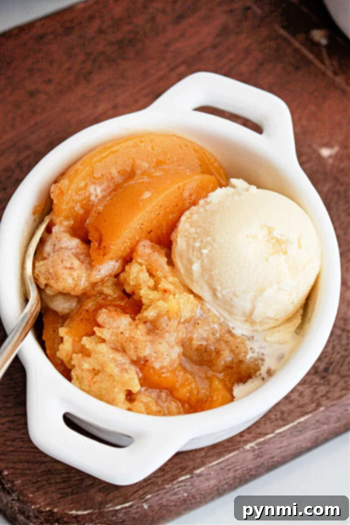 Crockpot Peach Cobbler with Cake Mix, full view on a wooden table