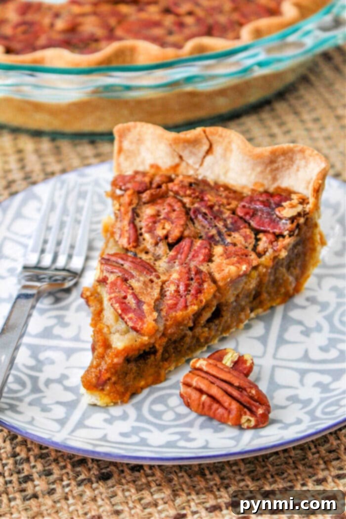 A stunning Pumpkin Pecan Pie, featuring a rich, golden pecan topping over a smooth pumpkin filling, nestled in a flaky crust, perfect for holiday gatherings.