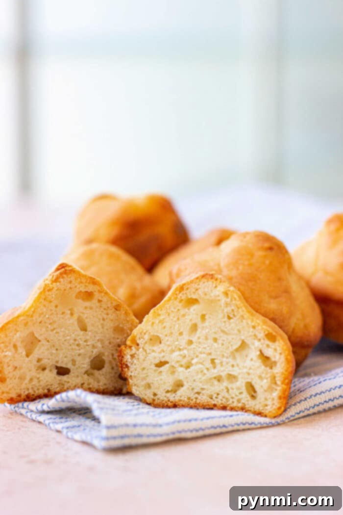 Two golden-brown mayonnaise biscuits stacked, ready to be served, highlighting their inviting texture.