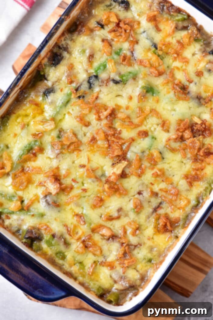 Green Bean Casserole Cheesy, a delicious holiday side dish with melted cheese and crispy onions.