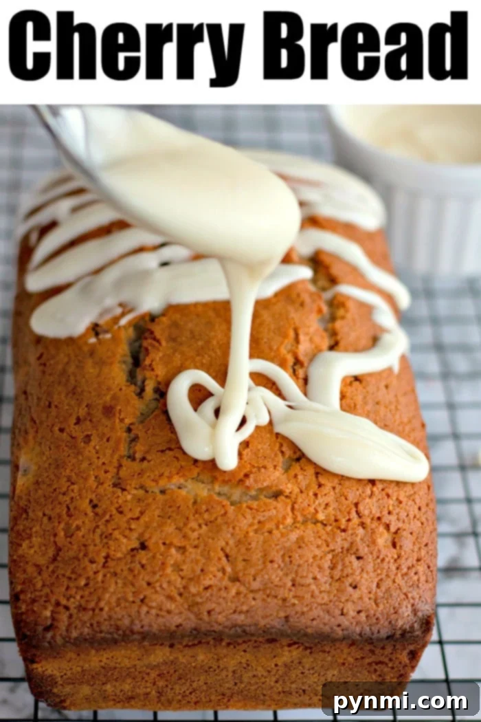 Enjoy the best cherry bread recipe with sweet maraschino cherries and a delicate glaze. Sliced Maraschino Cherry Bread on a white plate with a fork, ready to be eaten, showing the moist crumb and cherry pieces.