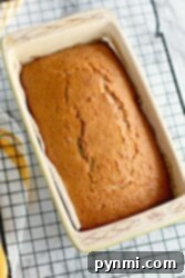 Sweet Cherry Loaf 7 A freshly baked Maraschino Cherry Bread loaf in a rectangular pan cools on a wire rack, inviting you with its sweet and enticing aroma.