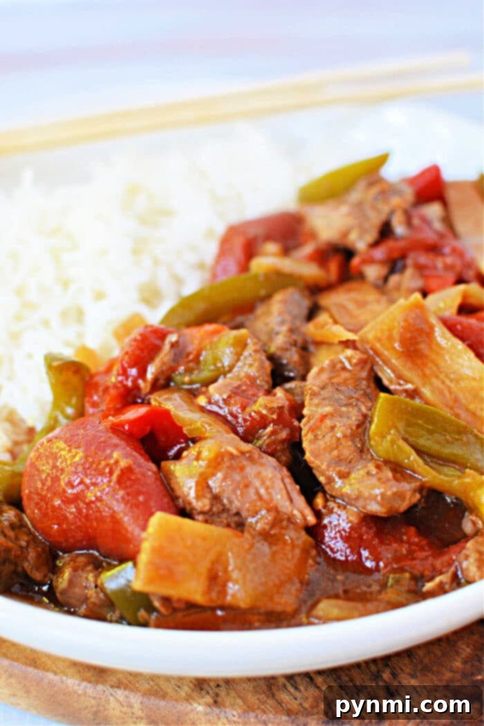 Close-up of Slow Cooker Chinese Pepper Steak, rich gravy and colorful peppers