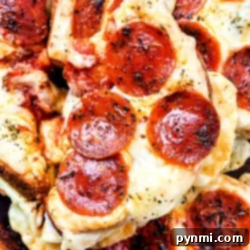 Close-up of Grilled Cheese Pizza Toast featuring pepperoni slices with melted cheese and herbs.
