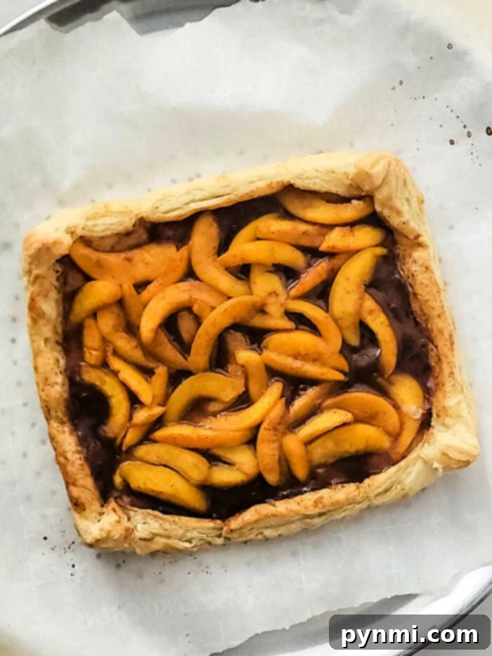 Baked Peach Tart, golden brown with perfectly cooked peaches and a flaky crust.